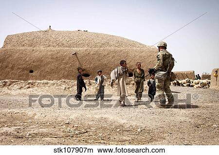 A Georgian Army soldier interacts with Afghan children. View Large Photo Image Picture - A Georgian Army soldier interacts with Afghan children.. Fotosearch