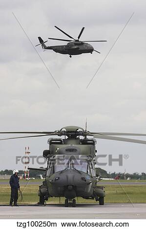 A German Army NH90 and its predecessor, the CH-53 Sea Stallion. View Large Photo Image Picture - A German Army NH90 and its predecessor, the CH-53 Sea Stallion.. Fotosearch