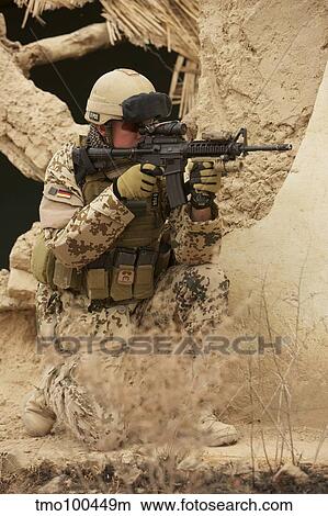 Picture - A German Army soldier armed with a M4 carbine.. Fotosearch