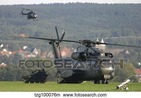 A German CH-53G helicopter unloads a Wiesel armored vehicle. View Large Photo Image Picture - A German CH-53G helicopter unloads a Wiesel armored vehicle.. Fotosearch