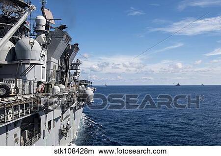 A gorup of military ships transit the South China Sea. View Large Photo Image Picture - A gorup of military ships transit the South China Sea.. Fotosearch