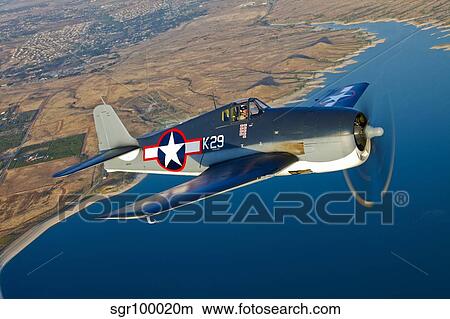 A Grumman F6F Hellcat fighter plane in flight. View Large Photo Image Picture - A Grumman F6F Hellcat fighter plane in flight.. Fotosearch
