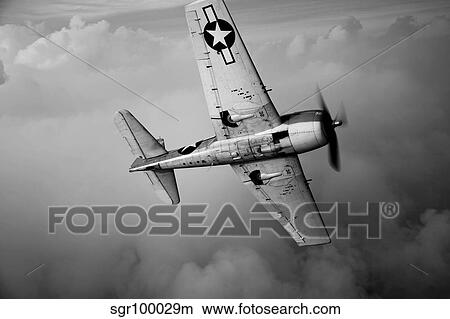 A Grumman F6F Hellcat fighter plane in flight. View Large Photo Image Picture - A Grumman F6F Hellcat fighter plane in flight.. Fotosearch