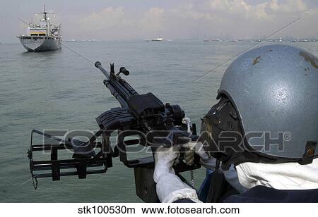 A gunner keeps his sight on the Military Sealift Command combat stores ship USNS Concord. View Large Photo Image Picture - A gunner keeps his sight on the Military Sealift Command combat stores ship USNS Concord.. Fotosearch