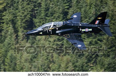 A Hawk T1 trainer aircraft of the Royal Air Force low flying over North Wales. View Large Photo Image Picture - A Hawk T1 trainer aircraft of the Royal Air Force low flying over North Wales.. Fotosearch
