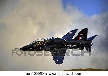 A Hawk T1 trainer aircraft of the Royal Air Force low flying over North Wales. View Large Photo Image Picture - A Hawk T1 trainer aircraft of the Royal Air Force low flying over North Wales.. Fotosearch