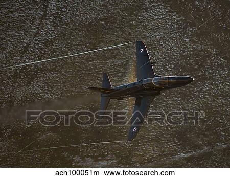 A Hawk T1 trainer aircraft of the Royal Air Force low flying over North Wales. View Large Photo Image Picture - A Hawk T1 trainer aircraft of the Royal Air Force low flying over North Wales.. Fotosearch
