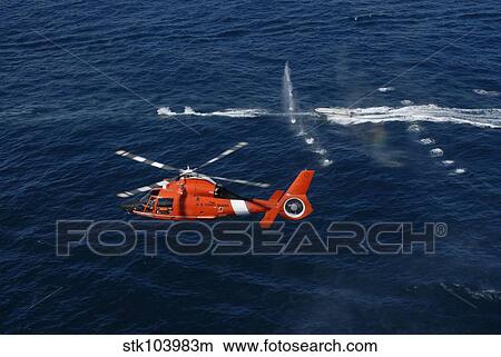 A helicopter crew trains off the coast of Jacksonville, Florida. View Large Photo Image Picture - A helicopter crew trains off the coast of Jacksonville, Florida.. Fotosearch