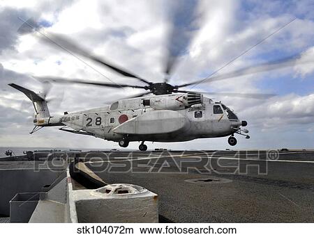 Picture - A Japanese Maritime Self-Defense Force MH-53 Sea Stallion lands on the flight deck of USS Denver.. Fotosearch