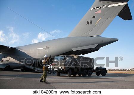 A Japanese soldier marshals vehicles from a C-17 Globemaster III. View Large Photo Image Picture - A Japanese soldier marshals vehicles from a C-17 Globemaster III.. Fotosearch