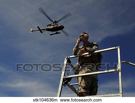 Picture - A Joint Terminal Attack Controller communicates a close air support mission.. Fotosearch