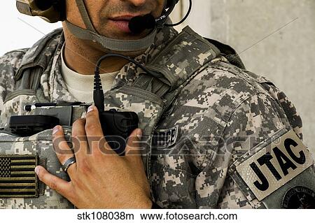 A Joint Terminal Attack Controller talks on his radio. View Large Photo Image Picture - A Joint Terminal Attack Controller talks on his radio.. Fotosearch