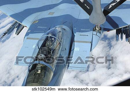 A KC-135 Stratotanker provides in-flight refueling to an F-15 Eagle. View Large Photo Image Picture - A KC-135 Stratotanker provides in-flight refueling to an F-15 Eagle.. Fotosearch