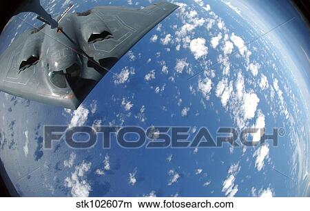 A KC-135 Stratotanker refuels a B-2 Spirit over the Pacific Ocean. View Large Photo Image Picture - A KC-135 Stratotanker refuels a B-2 Spirit over the Pacific Ocean.. Fotosearch