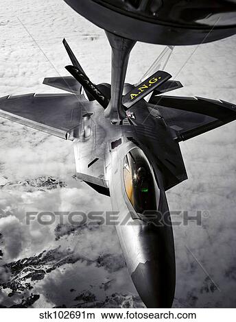 A KC-135 Stratotanker refuels a F-22 Raptor. View Large Photo Image Picture - A KC-135 Stratotanker refuels a F-22 Raptor.. Fotosearch