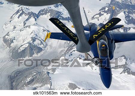 A KC-135 Stratotanker refuels an F/A-18 Hornet. View Large Photo Image Picture - A KC-135 Stratotanker refuels an F/A-18 Hornet.. Fotosearch