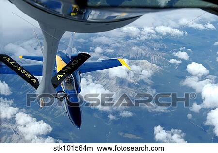 A KC-135 Stratotanker refuels an F/A-18 Hornet. View Large Photo Image Picture - A KC-135 Stratotanker refuels an F/A-18 Hornet.. Fotosearch