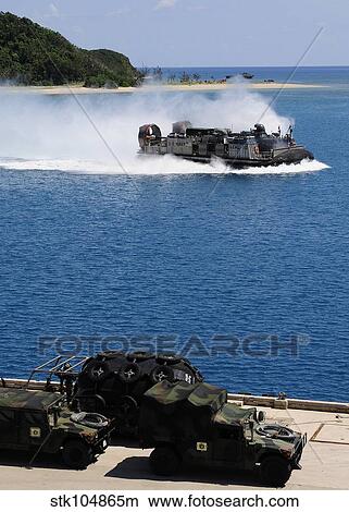 A landing craft air cushion approaches the well deck of USS Denver. View Large Photo Image Picture - A landing craft air cushion approaches the well deck of USS Denver.. Fotosearch