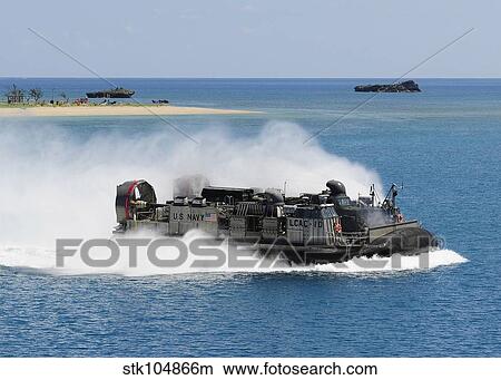 A landing craft air cushion approaches the well deck of USS Denver. View Large Photo Image Picture - A landing craft air cushion approaches the well deck of USS Denver.. Fotosearch