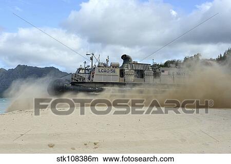 Picture - A landing craft air cushion departs for an equipment offload.. Fotosearch