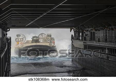 A landing craft air cushion enters the well deck of USS Rushmore. View Large Photo Image Picture - A landing craft air cushion enters the well deck of USS Rushmore.. Fotosearch