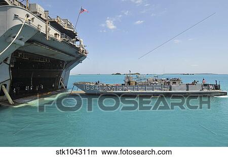 A landing craft utility approaches the well deck of USS Essex. View Large Photo Image Picture - A landing craft utility approaches the well deck of USS Essex.. Fotosearch