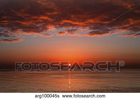 A layer of clouds is lit by the rising sun over Rio de la Plata, Buenos Aires, Argentina. View Large Photo Image Stock Photograph - A layer of clouds is lit by the rising sun over Rio de la Plata, Buenos Aires, Argentina.. Fotosearch
