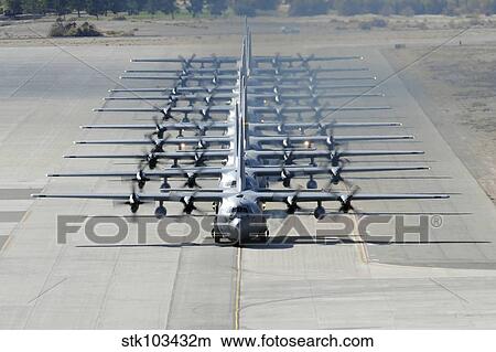 A line of C-130 Hercules taxi at Nellis Air Force Base, Nevada. View Large Photo Image Picture - A line of C-130 Hercules taxi at Nellis Air Force Base, Nevada.. Fotosearch