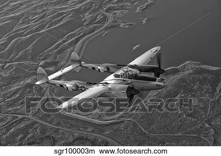 A Lockheed P-38 Lightning fighter aircraft in flight. View Large Photo Image Picture - A Lockheed P-38 Lightning fighter aircraft in flight.. Fotosearch