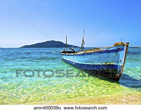 A lone boat on the shore of Cayos Cochinos, Honduras. View Large Photo Image Stock Photograph - A lone boat on the shore of Cayos Cochinos, Honduras.. Fotosearch