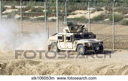 Picture - A M1114 Humvee patrols the perimeter of Joint Bae Balad, Iraq.. Fotosearch