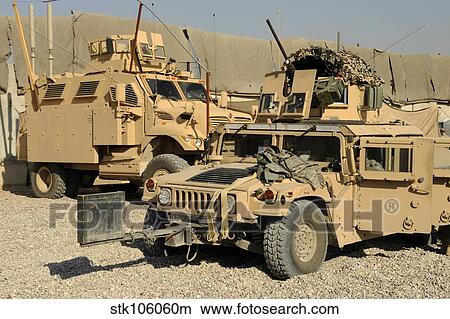 Picture - A M1114 humvee sits parked in front of a MaxxPro MRAP.. Fotosearch