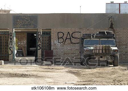 Picture - A M998 humvee parked outside an abandoned school.. Fotosearch