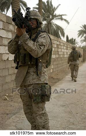 A machine gunner uses his scope to get a better look at a position during a patrol. View Large Photo Image Picture - A machine gunner uses his scope to get a better look at a position during a patrol.. Fotosearch
