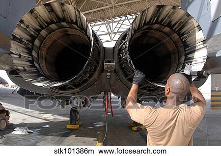 A maintainer inspects the engine of an F-15E Strike Eagle. View Large Photo Image Picture - A maintainer inspects the engine of an F-15E Strike Eagle.. Fotosearch