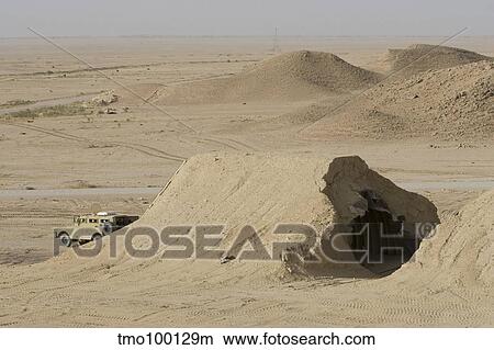 A Mamba armored vehicle sits in front of a Iraqi Magazine that has been hit by a coalition bomb. View Large Photo Image Picture - A Mamba armored vehicle sits in front of a Iraqi Magazine that has been hit by a coalition bomb.. Fotosearch