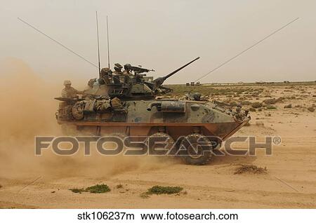 A Marine Corps Light Armored Vehicle kicks up a cloud of dust. View Large Photo Image Picture - A Marine Corps Light Armored Vehicle kicks up a cloud of dust.. Fotosearch