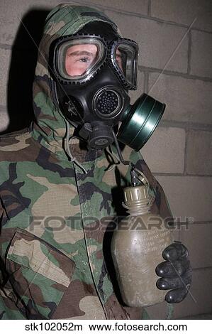 A Marine drinks water from his canteen through his gas mask inside a gas chamber. View Large Photo Image Picture - A Marine drinks water from his canteen through his gas mask inside a gas chamber.. Fotosearch