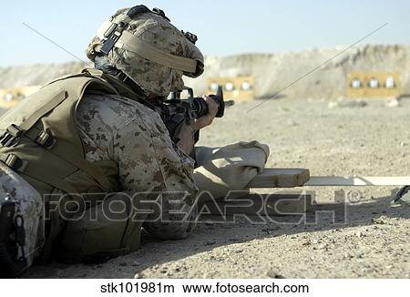 Picture - A Marine fires a M16A2 service rifle to acquire a battle sight zero.. Fotosearch