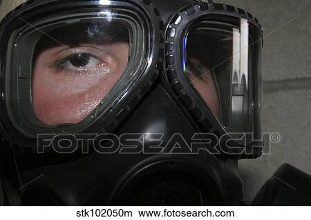A Marine glares through the limited-spaced eye protection part of his gas mask. View Large Photo Image Picture - A Marine glares through the limited-spaced eye protection part of his gas mask.. Fotosearch