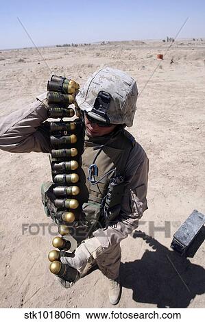 A marine handles a string of 40 mm high-explosive grenades. View Large Photo Image Picture - A marine handles a string of 40 mm high-explosive grenades.. Fotosearch