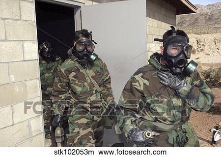 Picture - A Marine holds his chest displaying relief as Marines and Sailors exit the gas chamber.. Fotosearch