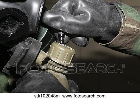 A Marine inserts a drinking tube into his canteen. View Large Photo Image Picture - A Marine inserts a drinking tube into his canteen.. Fotosearch