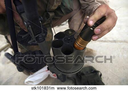Picture - A Marine loads 40 mm grenades.. Fotosearch