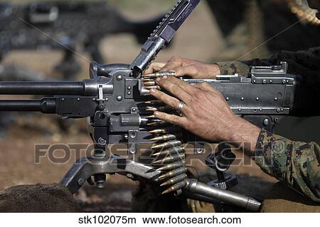 A Marine loads a M-240G machine gun. View Large Photo Image Picture - A Marine loads a M-240G machine gun.. Fotosearch