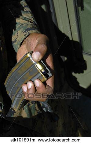 A Marine loads blank ammunition rounds into a magazine. View Large Photo Image Picture - A Marine loads blank ammunition rounds into a magazine.. Fotosearch