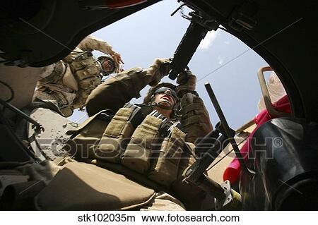 Picture - A marine rocks his M-2. 50-caliber machine gun.. Fotosearch