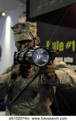 A marine tests the Night Hunter II, a rifle mountable flashlight. View Large Photo Image Picture - A marine tests the Night Hunter II, a rifle mountable flashlight.. Fotosearch