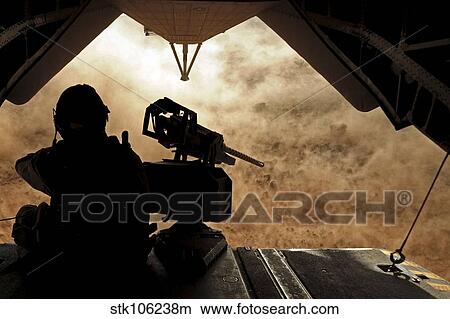 A Marine waits for dust to clear while sitting on a CH-53 Super Stallion. View Large Photo Image Picture - A Marine waits for dust to clear while sitting on a CH-53 Super Stallion.. Fotosearch