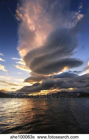 Stock Photograph - A massive stacked lenticular cloud over Tjedsundet in Troms County, Norway.. Fotosearch